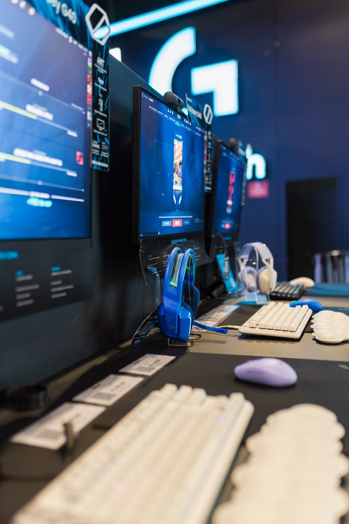 Services A contemporary gaming setup featuring multiple monitors, keyboards, and headphones in a vertical angle.