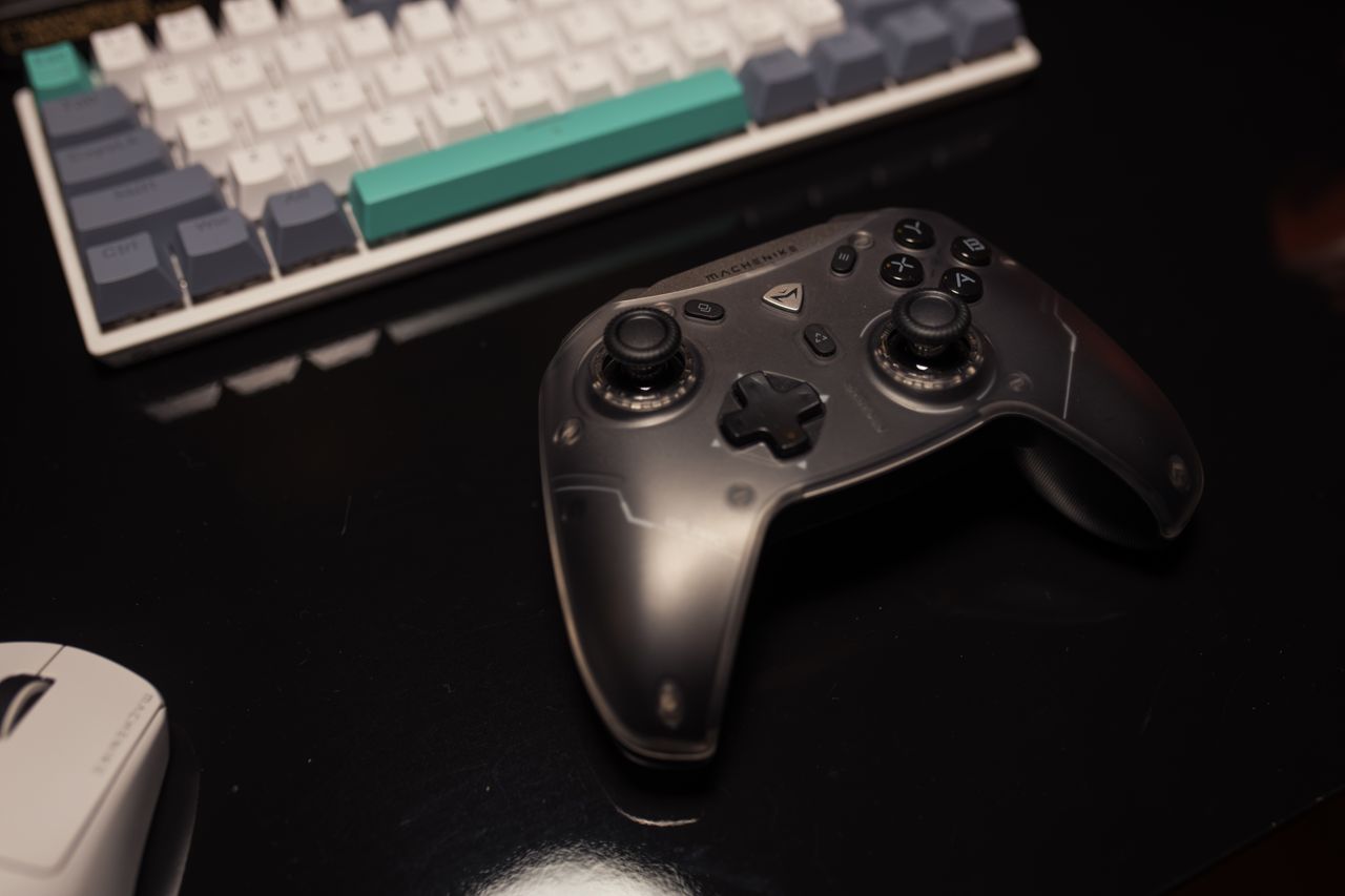 Close-up of a gaming controller on a desk with a keyboard and mouse, perfect for gamers.